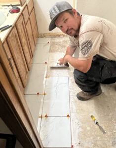 On-site handyman services: Laying down ceramic floor tiles