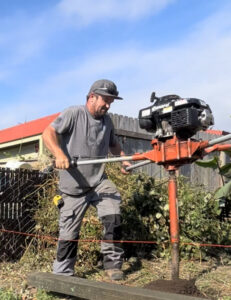 On-site handyman services: Drilling a post hole in preparation for building a fence